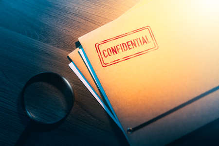 Private investigator desk with confidential envelopesの写真素材