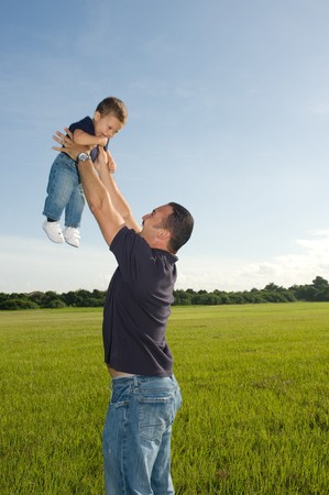 Father and Son Playing Outdoors at the Park smilingの写真素材