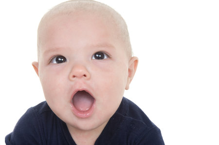 Adorable baby boy making a surprised happy face 