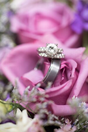 Beautiful wedding rings in lavender rose bouquetの写真素材