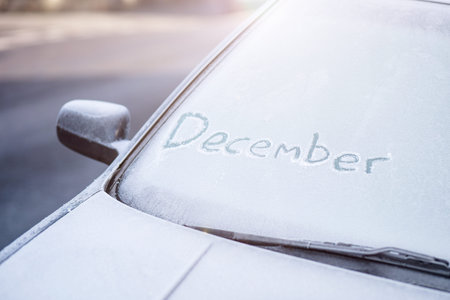 The word December written onto a frosted car windscreen