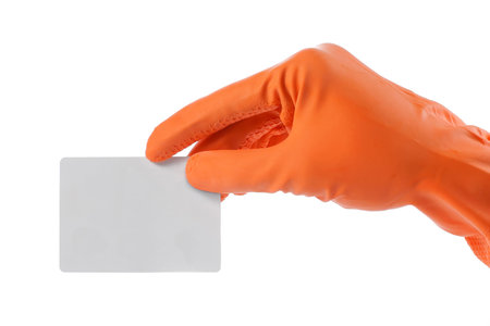 hand with orange glove holding a blank cardの写真素材