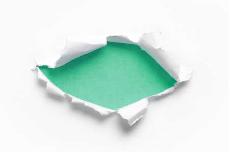 ripped white paper against a blue backgroundsの写真素材