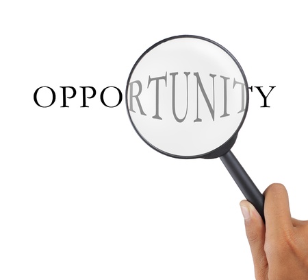 hand with magnifier glass and opportunity textの写真素材