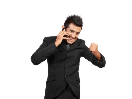 happy businessman talking over the cell phone. isolated on whiteの写真素材