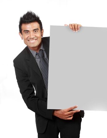 young Businessman holding a blank sign isolated over white backgroundの写真素材