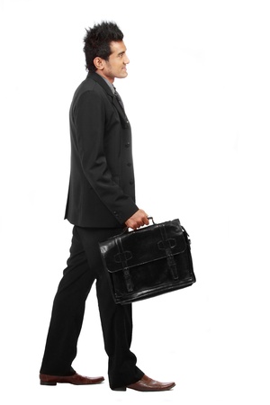 A young businessman is walking. isolated over white backgroundの写真素材