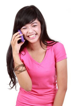 Attractive woman on the phone laughing against white backgroundの写真素材
