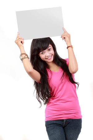 Portrait of a cute young woman holding a blank card up on her face isolated over white backgroundの写真素材