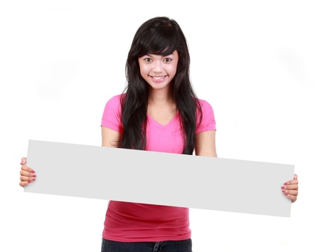 Portrait of a happy female holding blank white long card isolated on whiteの写真素材
