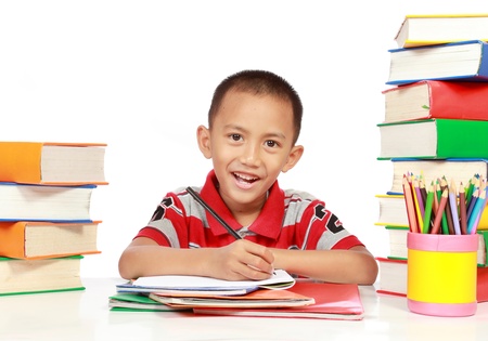 portrait of little boy smiling while studyingの写真素材