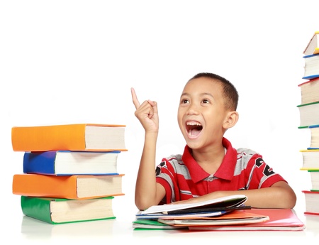 Portrait of happy joyful little boy pointing into copy space against on white backgroundの写真素材