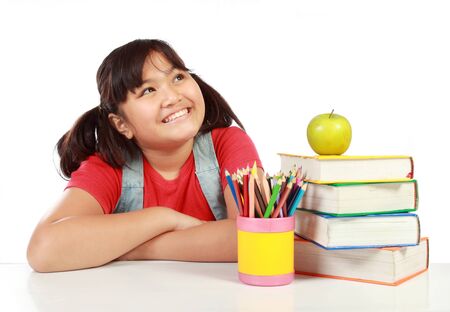 happy schoolgirl studying with many booksの写真素材