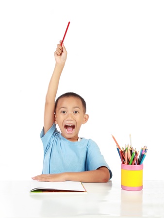 confident little schoolboy lift up his hand to answer the questionの写真素材