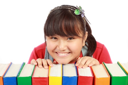 Little girl holding pile of booksの写真素材