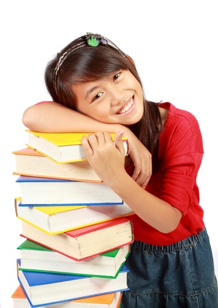 happy Little girl holding pile of books の写真素材