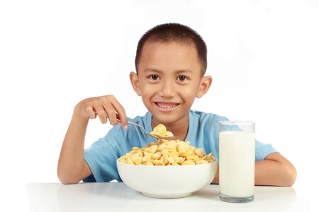 kid's love to having breakfast with milk. isolated over white backgroundの写真素材