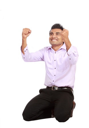 Portrait of an excited young business man celebrating success with good expression against white backgroundの写真素材