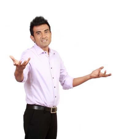 Portrait of casual young man gesturing do not know sign against white backgroundの写真素材