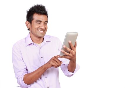 Attractive man with touchpad isolated on white backgroundの写真素材