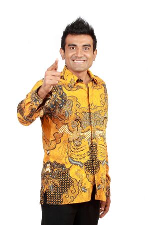 Attractive asian man pointing isolated on white backgroundの写真素材