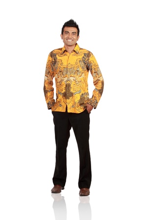 Full length portrait of young man standing with hands in pockets over white backgroundの写真素材