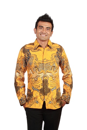 Portrait of happy smiling man wearing batik, isolated on white backgroundの写真素材