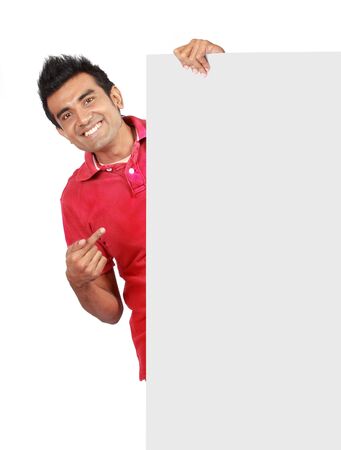 man in nice red shirt smiling holding a big blank cardの写真素材