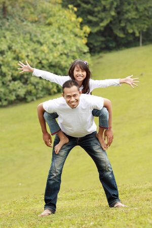 Daughter with her father in the park having funの写真素材