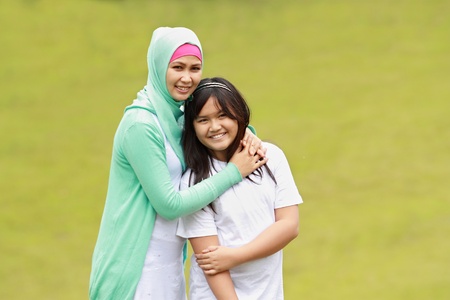 beautiful young mother and her daughter having funの写真素材