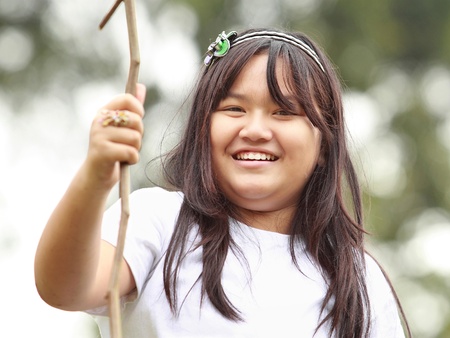 Smiling girl on the park looking right at cameraの写真素材