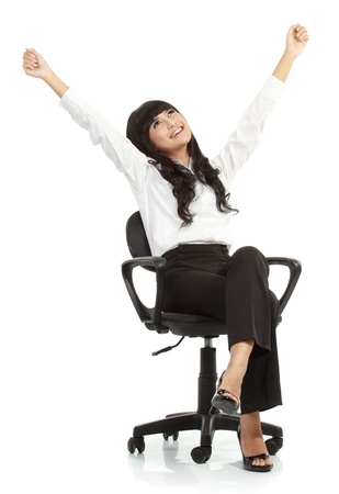 Pretty excited young woman sitting on chair celebrating victory - Isolated on white backgroundの写真素材