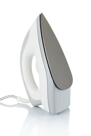 Electric iron isolated on white background with shadowの写真素材