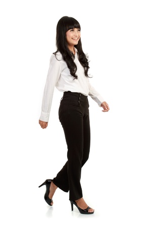 
Full body portrait of walking businesswoman, full isolated on whiteの写真素材