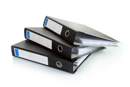 Stack of documents in binders against white background. Office life.の写真素材