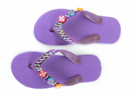 a pair of purple beach shoes isolated on whiteの写真素材