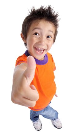 Portrait of a smilling cute little boy gesturing thumbs up sign agaist white backgroundの写真素材