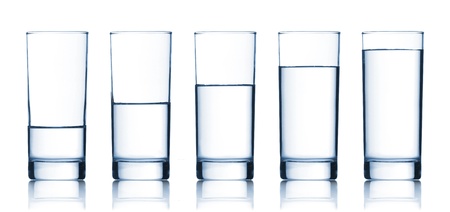 set of glasses filled with water on white backgroundの写真素材