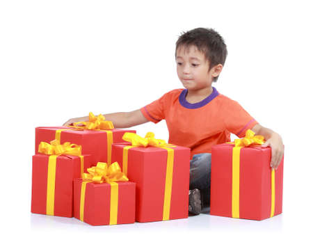 Child with stack gift box. Isolated in white baackgroundの写真素材