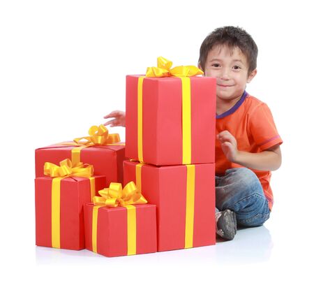 Child with stack gift box. Isolated in white baackgroundの写真素材