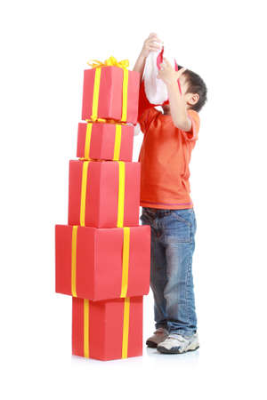 Child with stack gift box. Isolated in white baackgroundの写真素材