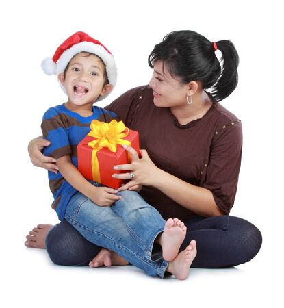 Cheerful boy in Santa Claus hat and his mom  Isolated on white backgroundの写真素材