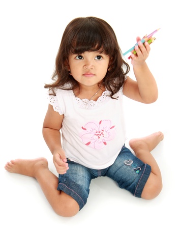portrait little pretty girl holding pencil color on a white backgroundの写真素材