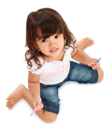 portrait of cute little pretty girl hold pencil color on a white backgroundの写真素材
