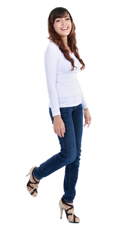 Full length image of an attractive young girl walking over white backgroundの写真素材