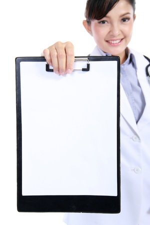 Woman doctor / Nurse showing blank clipboard sign - a medical concept. isolated on white backgroundの写真素材