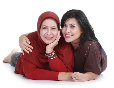 muslim woman with her daughter  lying on isolated over white backroundの写真素材
