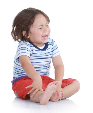 Little boy crying in isolated white backgroundの写真素材