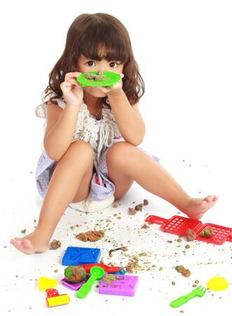 Ecstatic little girl playing with her clayの写真素材