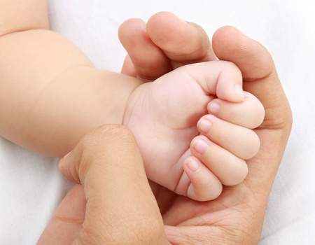 little baby hand with mother's handの写真素材
